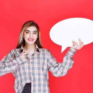 girl-checked-sweater-holding-ovale-ideaboard-pointing-it-with-finger_144627-66463