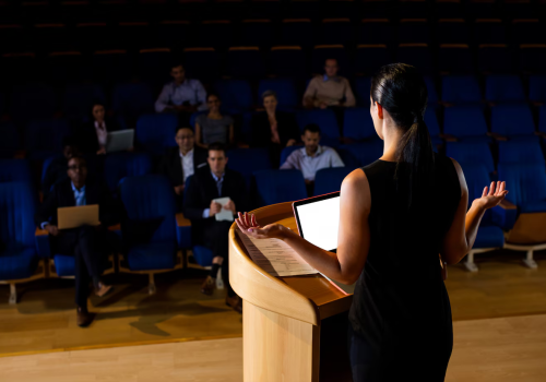 rear-view-female-business-executive-giving-speech_107420-63815